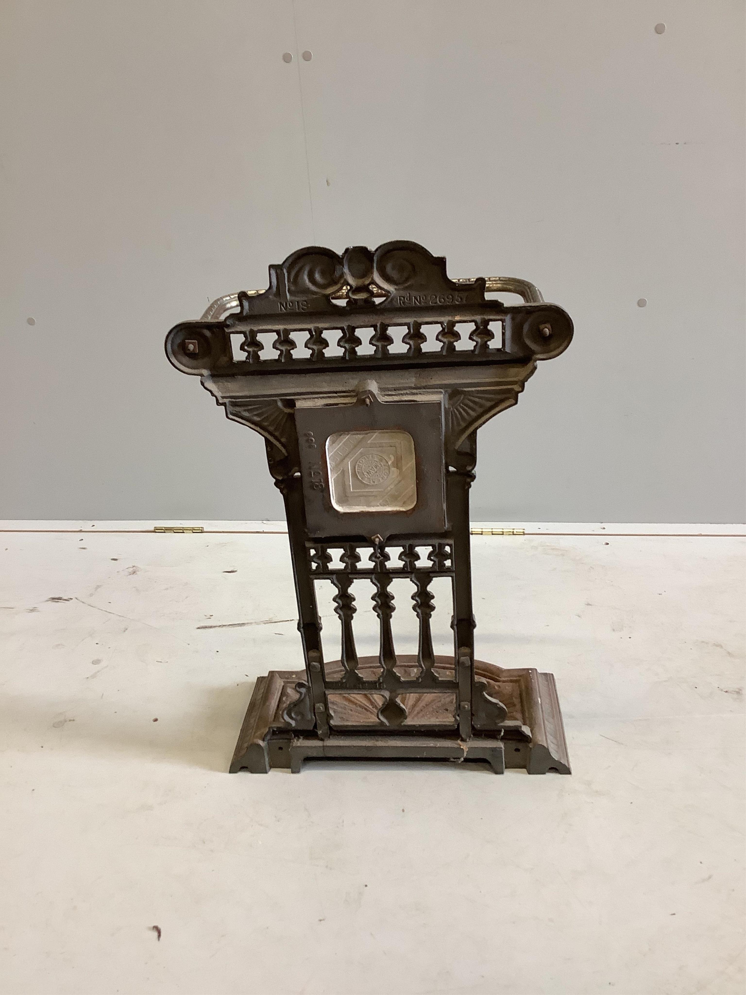 A Victorian steel stick stand with tile inset back, width 44cm, height 71cm. Condition - fair